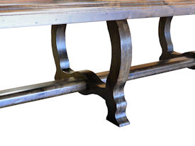 Distressed face grain Walnut trestle-style dining table with mortise and tenon jointery.