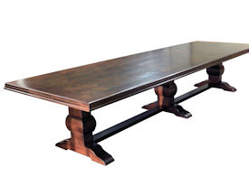 Distressed herringbone mesquite trestle-style dining table with Walnut banding and Walnut leaves.  Through mortise and tenon jointery.  Custom Stain.