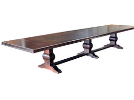 Distressed herringbone mesquite trestle-style dining table with Walnut banding and Walnut leaves.  Through mortise and tenon jointery.  Custom Stain.
