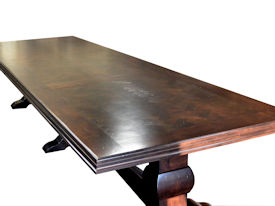 Distressed herringbone mesquite trestle-style dining table with Walnut banding and Walnut leaves.  Through mortise and tenon jointery.  Custom Stain.