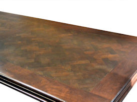 Distressed herringbone mesquite trestle-style dining table with Walnut banding and Walnut leaves.  Through mortise and tenon jointery.  Custom Stain.