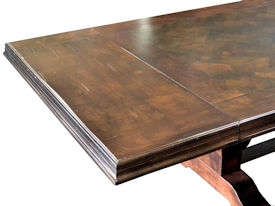 Distressed herringbone mesquite trestle-style dining table with Walnut banding and Walnut leaves.  Through mortise and tenon jointery.  Custom Stain.