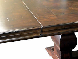 Distressed herringbone mesquite trestle-style dining table with Walnut banding and Walnut leaves.  Through mortise and tenon jointery.  Custom Stain.