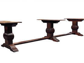 Distressed herringbone mesquite trestle-style dining table with Walnut banding and Walnut leaves.  Through mortise and tenon jointery.  Custom Stain.