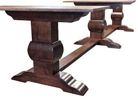 Distressed herringbone mesquite trestle-style dining table with Walnut banding and Walnut leaves.  Through mortise and tenon jointery.  Custom Stain.